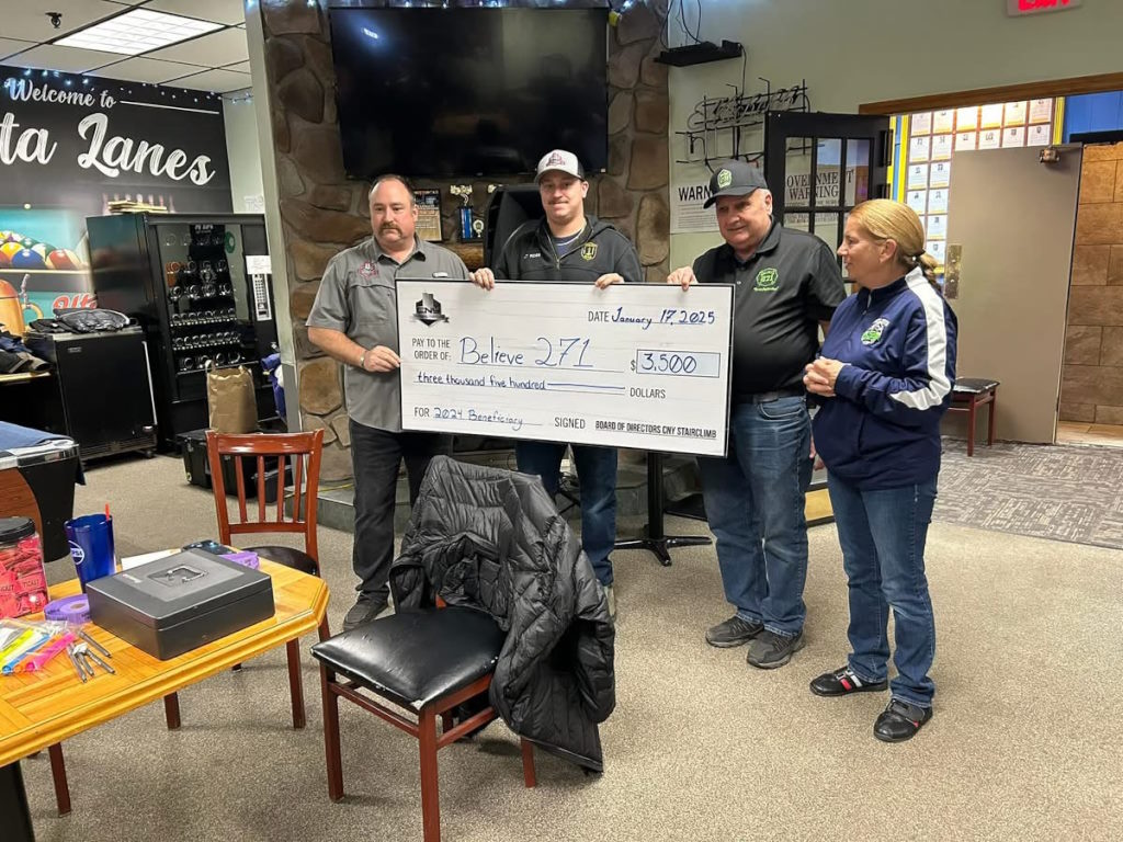 Members holding up $5,000 donation check