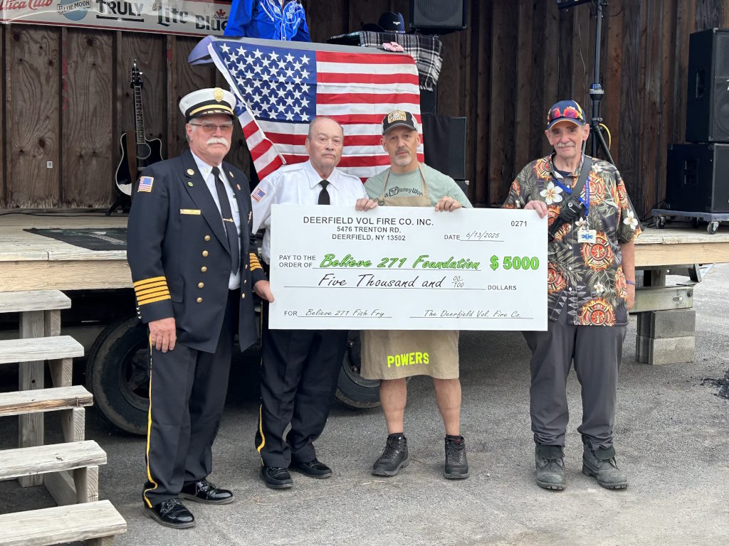Members holding up $5,000 donation check